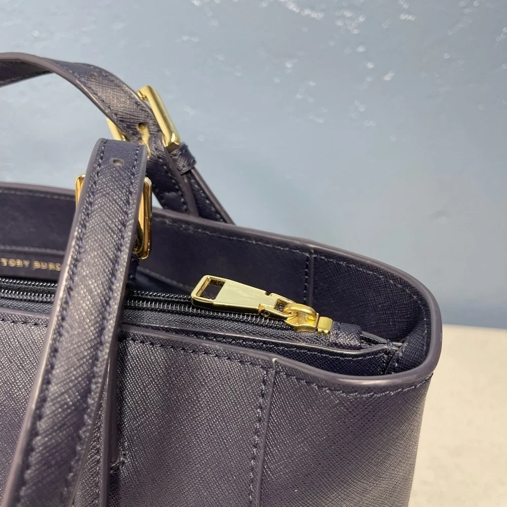 Tory Burch Saffiano leather medium Navy Blue top zip tote with material inside.